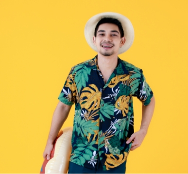 young-asian-man-colorful-printed-hawaiian-shirt-smiles-with-happiness-while-holding-swim-ring-full-body-studio-portrait-yellow-background-summer-holiday-travel-concept
